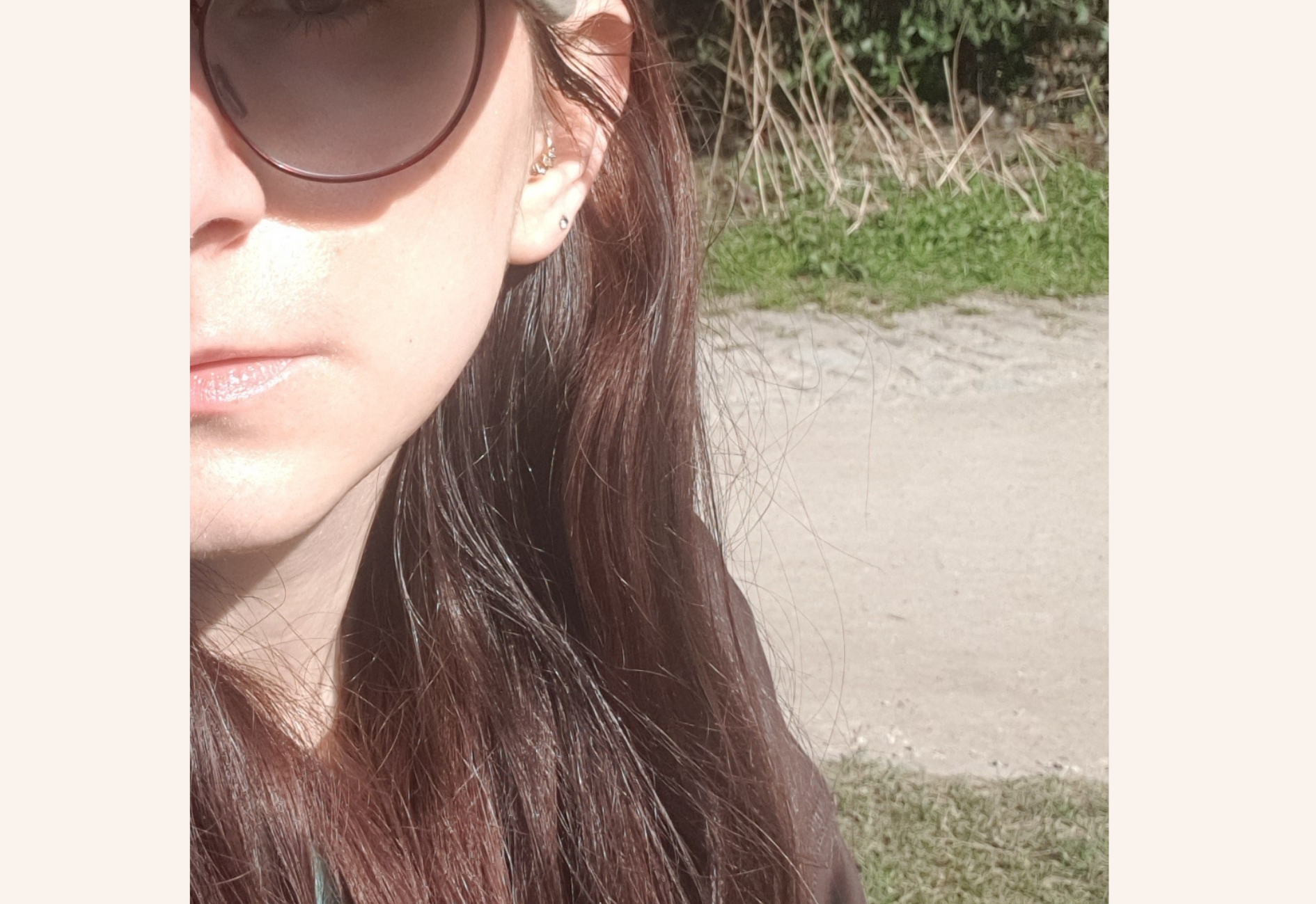 Applying SUNdance 50 SPF sunscreen on face, showing a shiny finish